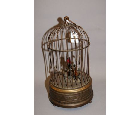A clockwork automaton bird cage, brass with two chirping feathered birds within, in full working order. CONDITION REPORT; Ava