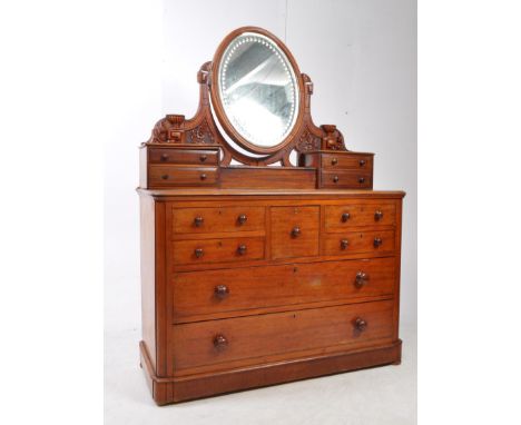 A 19th century Victorian mahogany dressing chest of drawers. The chest featuring a series of drawers to lower, with central h
