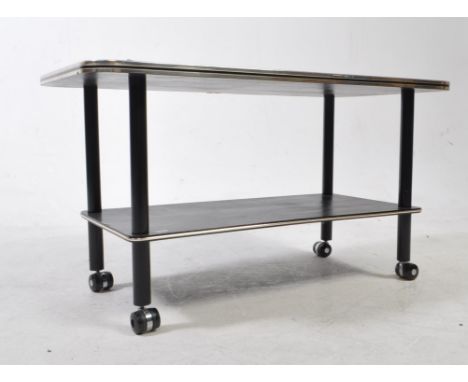 A vintage 1950's retro coffee table of rectangular form having inset backgammon style top raised on turned ebonised supports 