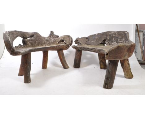 Rustic form tree trunk garden benches raised on thick post supports with carved tree trunk seats. Together with another (2) M