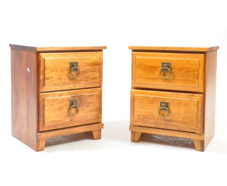 Contemporary pair of hardwood bedside chests / tables. Each with twin drawers, pull handles on bracket feet. Measures approx: