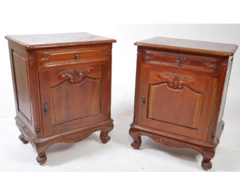 A pair of French mahogany bedside cabinets. Raised on stub cabriole legs with single locker doors having short drawers above.