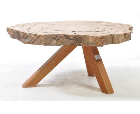 Contemporary living edge coffee / occasional table. Polised central trunk top raised over splayed legs. Measures approx: 29x6