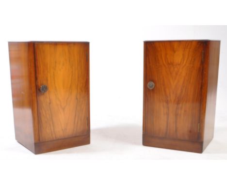 Two early 20th century circa 1940s oak veneer bedside cabinets / pot cupboards. The bedsides raised on plinth bases, with sin