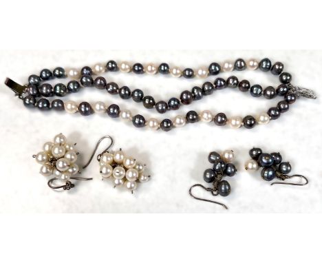 A 3 strand white and grey cultured pearl bracelet, knotted, a similar pair of earrings and another pair of white pearls in a 