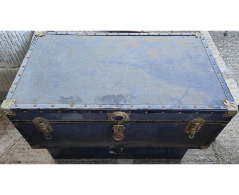 A blue cabin trunk and a metal cabin trunk 