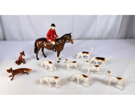 A Beswick Fox Hunting set of huntsmen, 8 hounds and 2 foxes 