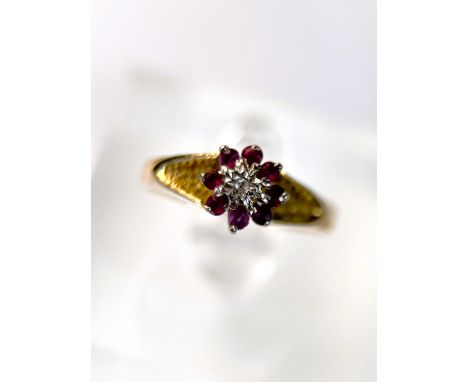 An 18 carat hallmarked gold dress ring illusion set with red and clear stones, 2.8gm size N/O 