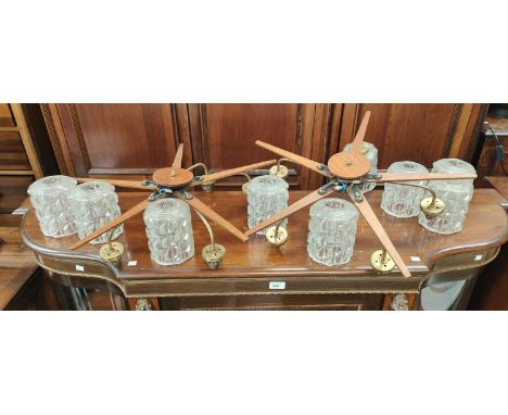 A pair of mid 20th century teak star shaped light fittings with glass shades&nbsp; 