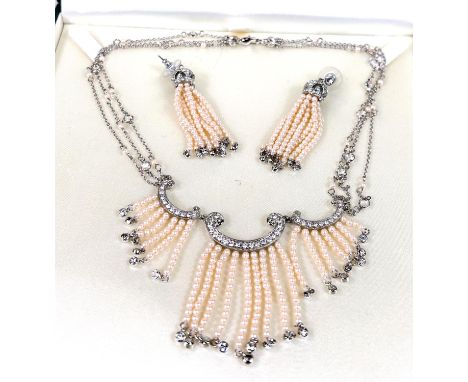 A diamante and faux seed pearl necklace on triple chain with matching earrings, boxed 