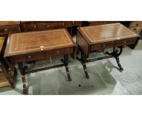 A pair of reproduction mahogany sofa tables with inset leather tops on lyre ends and splay feet 