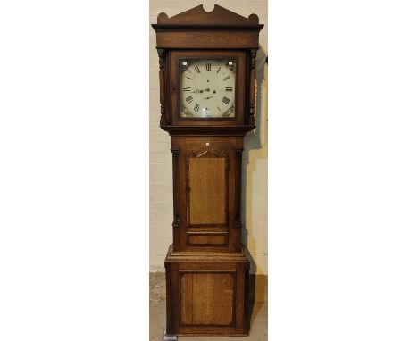 An early 19th century oak and mahogany longcase clock with architectural pediment and turned columns to the hood, triple arch