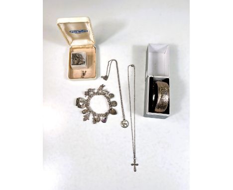 A silver char, bracelet, a cross on chain, a silver napkin ring, boxed etc 