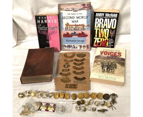 A collection of military shoulder badges on board, a collection of buttons etc and books including first edition 'The Story o