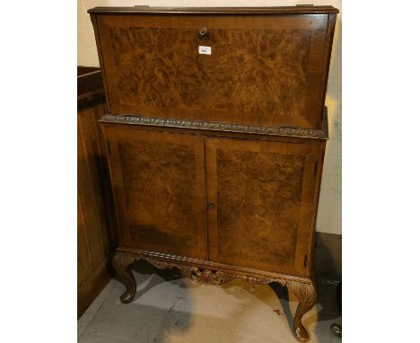 A reproduction Queen Anne style burr walnut drinks cabinet with fall front double cupboard and cabriole legs 