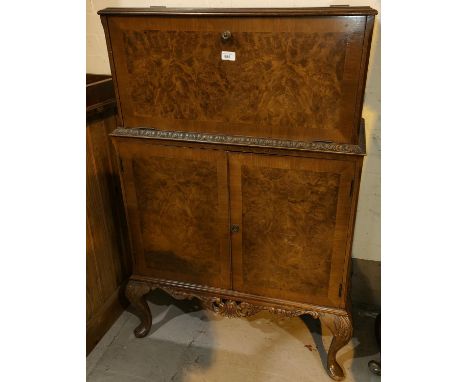 A reproduction Queen Anne style burr walnut drinks cabinet with fall front double cupboard and cabriole legs 