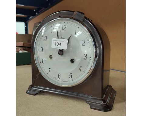 A mid 20th century bakelite cased mantle clock with silvered dial and striking movement by Enfield, ht. 20cm 