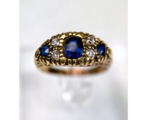 A Victorian style 18ct hallmarked gold sapphire and diamond ring, length of central stone, approx 6mm, 7gm 