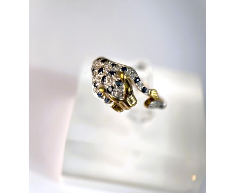 A 9ct hallmarked gold ring in the form of a leopard pouncing set with small sapphires and illusion set diamond chips, 2.9gm, 