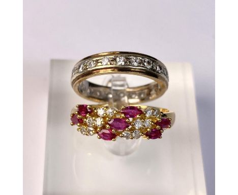 A yellow metal dress ring set with diagonal bands of rubies and diamonds (markes rubbed) 3.9gm, size Q; an eternity ring set 