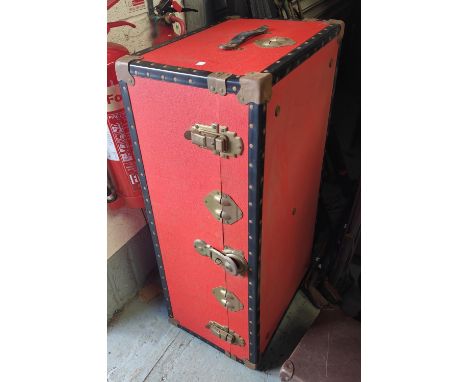 A large red cabin trunk 