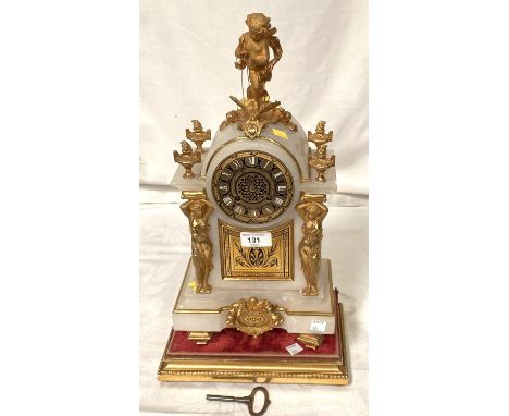 A Louis XVI style white marble mantle clock with gilt metal cherub finial and mounts with base and stand, having French drum 