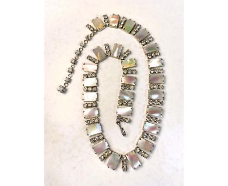 A mid 20th century cocktail necklace formed from rectangular pieces of mother of pearl, each interspersed with 3 diamantes 