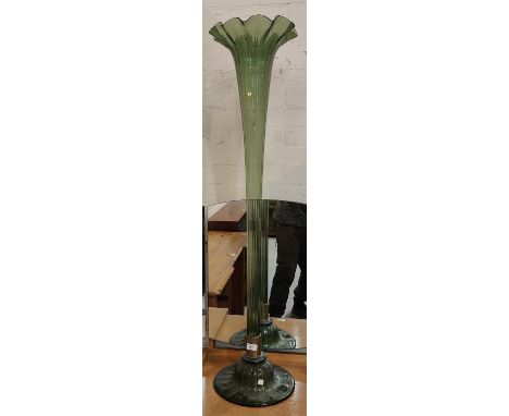 A large floor standing trumpet vase in green glass, 124cm 