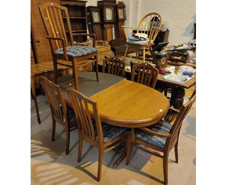 A Staf light teak extending dining table with extra interior leaf and a set of 6 (4+2) chairs 