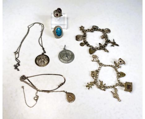 A white metal bark effect ring set with garnets; 2 white metal charm bracelets, pendants etc 
