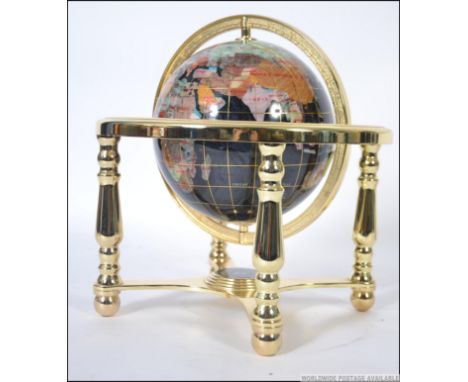 A small table top semi-precious stone inlaid terrestrial globe of the world, raised on a gilt metal gimble base, with compass