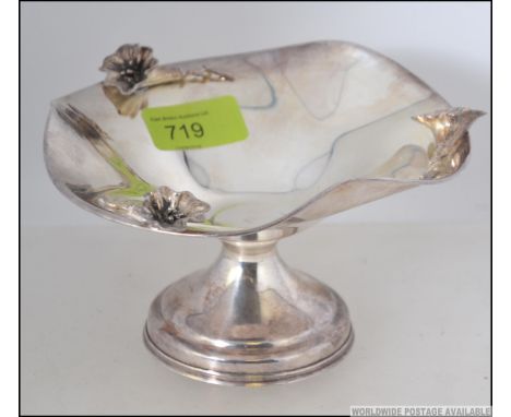 A 925 Italian silver tazza with embellished flowers to the sides on pedestal foot. The centre of the bowl marked with a Star 