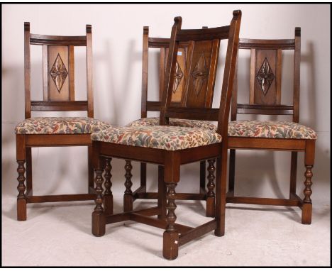 A set of 4 Old Charm oak dining chairs of good quality being raised on bobbin turned supports with drop in seats and panel ba