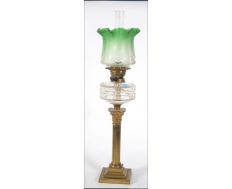 A stunning Victorian brass and glass oil lamp. The brass base with neo classical column upright, clear glass reservoir having