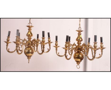A pair of 19th century Dutch style brass six light chandeliers with globular turned stems from which issue six out scrolling 