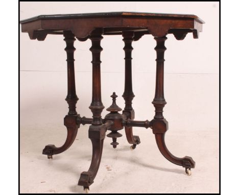 A Victorian mahogany and marquetry inlaid centre table raised on turned legs united by lower tier on stretchers. Ceramic cast