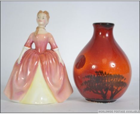 A Royal Doulton figurine entitled Debbie HN2400 together with a Poole pottery flambe bulbous vase. Measures: 16cms high.