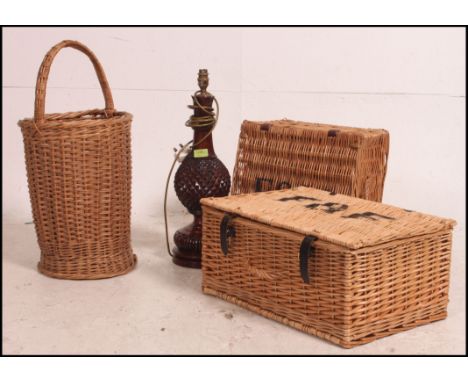 2 vintage whicker hampers together with an early 20th century stick stand / oyster basket and a carved hardwood table lamp. M