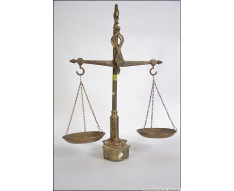 A Victorian travelling salesmans brass set of scales, the base with inset holes complete with the weights and the hanging sca