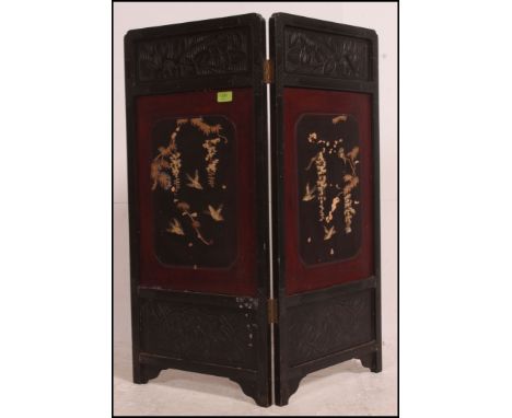 A 19th century Japanese laquered and inlaid two fold discretionary screen with fret work panel tops to each. Measures: 84cms 