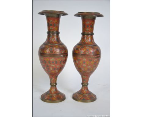 A pair of enamel painted engine turned Indian Gu style vases. The red painted bulbous bodies with trumpet necks. Measures: 32