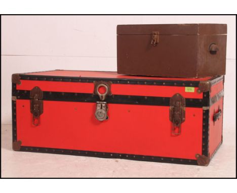 A retro style red canvas bound 20th century steamer trunk with hinged centre and black bindings