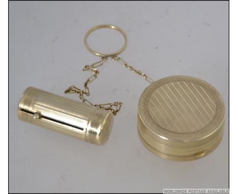 A vintage Houbigant of France Art Deco gilt metal Powder Compact and telescopic lipstick holder united by chain. Both with en