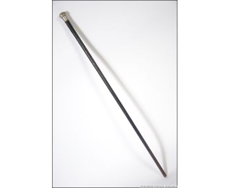 A silver hallmarked knop topped promenade cane with ebonised tapering shaft. Makers marks being rubbed. Measures: 85cms long.