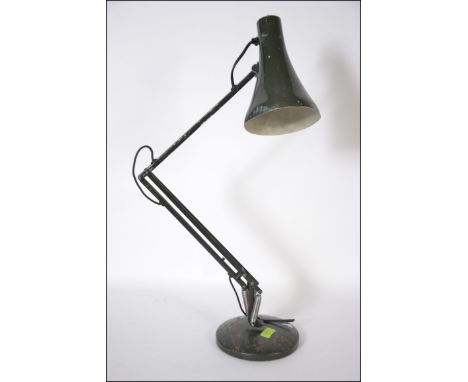 A 20th century retro Herbert Terry Anglepoise lamp in green raised on a circular base. Measures: 51cms high x 58cms diameter.