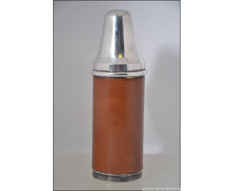 A good leather and silver plated hunting flask. Of cylindrical form, the flask of glass form with lid and multiple beakers co