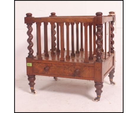 A Victorian mahogany barleytwist canterbury / magazine rack being raised on turned legs with brown ceramic castors. Single dr