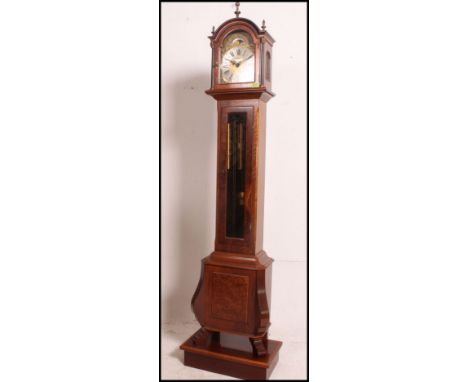 A modern burr walnut grandmother clock having a brass dial with silver chapter ring, figural spandrels, matted centre ad roll