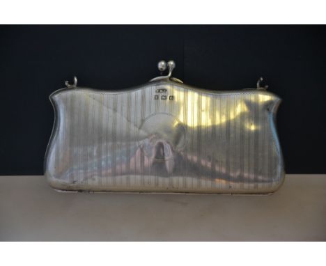 A silver hallmarked engine turned evening purse, having clasp atop with the purse having a hinged base, assay marks for Birmi