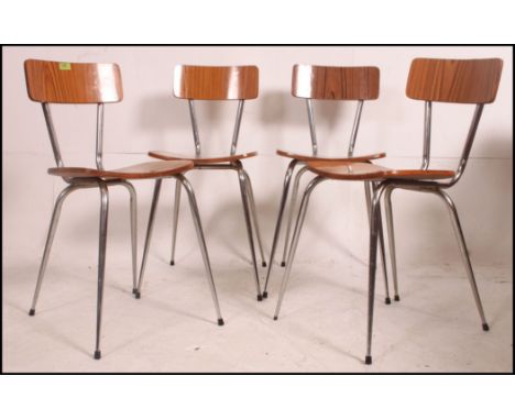 A set of 4 vintage 1970's retro Tavo Belgian dinette chairs raised on tubular metal supports with faux wood panel seats and b